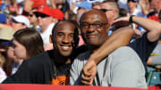 Kobe Bryant poses with his father, Joe Bryant, at a baseball game.