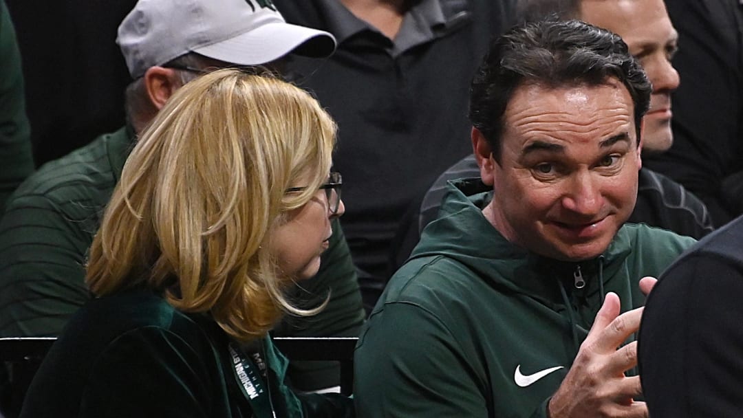 Nov 28, 2023; East Lansing, Michigan, USA; Michigan State   s new head football coach, Jonathan Smith, chats with MSU interim president Teresa Woodruff while the Michigan State Spartans play the Georgia Southern Eagles at Jack Breslin Student Events Center. Mandatory Credit: Dale Young-USA TODAY Sports