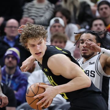 Mar 27, 2024; Salt Lake City, Utah, USA; Utah Jazz forward Lauri Markkanen (23) spins to the basket against San Antonio Spurs guard Tre Jones (33) during the fourth quarter at Delta Center. Mandatory Credit: Rob Gray-USA TODAY Sports