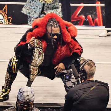 Swerve Strickland poses on the ring apron with the AEW World Championship at Forbidden Door 2024.