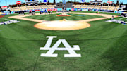 Oct 23, 2017; Los Angeles, CA, USA; Workers put finishing touches on the World Series logo and the field before today's workouts one day prior to game one of the World Series between the Los Angeles Dodgers and the Houston Astros at Dodger Stadium. Mandatory Credit: Jayne Kamin-Oncea-Imagn Images