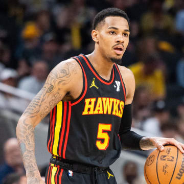 Apr 14, 2024; Indianapolis, Indiana, USA; Atlanta Hawks guard Dejounte Murray (5) dribbles the ball while Indiana Pacers guard Ben Sheppard (26) defends in the second half at Gainbridge Fieldhouse. Mandatory Credit: Trevor Ruszkowski-USA TODAY Sports