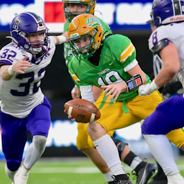 Brock Beaner, left, and Tyler Olson close in on a tackle during Anacortes' 60-30 win over Tumwater to win WIAA Class 2A title in 2023.