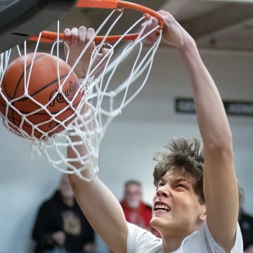 Green   s Nikola Bundalo dunks against McKinley on Friday, Feb. 3, 2023.

Mckinley Green Boys Basketball 002