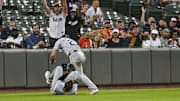 Sep 3, 2024; Baltimore, Maryland, USA;  Chicago White Sox third baseman Miguel Vargas (20) and outfielder Andrew Benintendi (23) react after colliding on Baltimore Orioles designated hitter Eloy Jiménez (not pictured) second inning fly ball  at Oriole Park at Camden Yards.