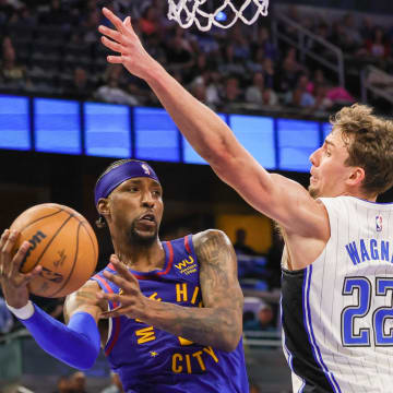 Denver Nuggets guard Kentavious Caldwell-Pope (5) passes the ball around Orlando Magic forward Franz Wagner (22) during the second quarter at Amway Center. 