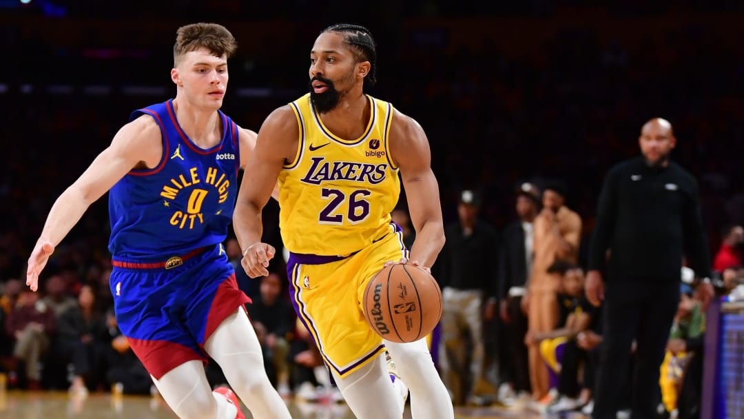 Apr 25, 2024; Los Angeles, California, USA; Los Angeles Lakers guard Spencer Dinwiddie (26) moves the ball ahead of Denver Nuggets guard Christian Braun (0) during the second half in game three of the first round for the 2024 NBA playoffs at Crypto.com Arena. Mandatory Credit: Gary A. Vasquez-USA TODAY Sports