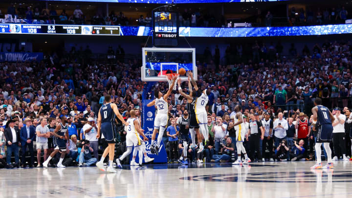 Apr 5, 2024; Dallas, Texas, USA;  Dallas Mavericks forward P.J. Washington (25) hits the game winning shot past Golden State Warriors guard Gary Payton II (0) and Golden State Warriors forward Trayce Jackson-Davis (32) during the fourth quarter at American Airlines Center. Mandatory Credit: Kevin Jairaj-USA TODAY Sports