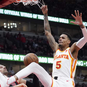 Apr 17, 2024; Chicago, Illinois, USA; Atlanta Hawks guard Dejounte Murray (5) dunks the ball on Chicago Bulls center Nikola Vucevic (9) during the second half during a play-in game of the 2024 NBA playoffs at United Center. Mandatory Credit: David Banks-USA TODAY Sports