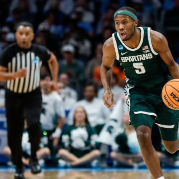 Michigan State guard Tre Holloman (5) looks to pass against North Carolina during the first half of the NCAA tournament West Region second round at Spectrum Center in Charlotte, N.C. on Saturday, March 23, 2024.