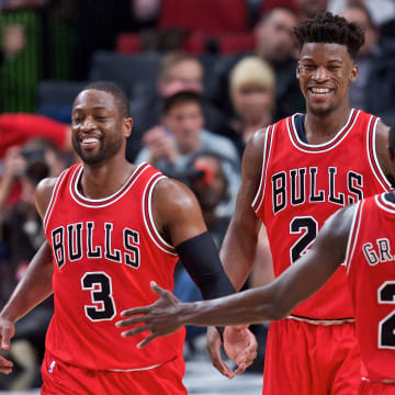 Nov 15, 2016; Portland, OR, USA; Chicago Bulls forward Taj Gibson (22) and guard Dwyane Wade (3) and forward Jimmy Butler (21) and guard Jerian Grant (2) react after a dunk by Wade against the Portland Trail Blazers during the third quarter at the Moda Center. Mandatory Credit: Craig Mitchelldyer-USA TODAY Sports
