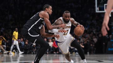 Mar 31, 2024; Brooklyn, New York, USA; Los Angeles Lakers forward LeBron James (23) dribbles against Brooklyn Nets center Nic Claxton (33) during the second half at Barclays Center. Mandatory Credit: Vincent Carchietta-USA TODAY Sports