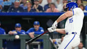 Sep 3, 2024; Kansas City, Missouri, USA; Kansas City Royals third baseman Paul DeJong (15) hits a one-run sacrifice against the Cleveland Guardians in the sixth inning at Kauffman Stadium. Mandatory Credit: Denny Medley-Imagn Images