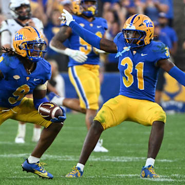 Sep 14, 2024; Pittsburgh, Pennsylvania, USA; Pittsburgh Panthers linebacker Kyle Louis celebrates with linebacker Rasheem Biles (31) after intercepting West Virginia Mountaineers quarterback Garrett Greene (6) in the fourth quarter at Acrisure Stadium. Mandatory Credit: Barry Reeger-Image Images