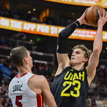 Dec 31, 2022; Salt Lake City, Utah, USA; Utah Jazz forward/center Lauri Markkanen (23) bumps into Miami Heat forward Nikola Jovic (5) before a shot during the second half at Vivint Arena. Mandatory Credit: Christopher Creveling-USA TODAY Sports