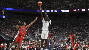 Jul 10, 2024; Las Vegas, Nevada, USA; USA guard Anthony Edwards (5) shoots over Canada guard Andrew Nembhard (19) in the second quarter of the USA Basketball Showcase at T-Mobile Arena. Mandatory Credit: Candice Ward-USA TODAY Sports