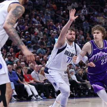 Mar 25, 2024; Salt Lake City, Utah, USA; Utah Jazz forward Lauri Markkanen (23) drives against Dallas Mavericks guard Luka Doncic (77) during the third quarter at Delta Center. Mandatory Credit: Rob Gray-USA TODAY Sports