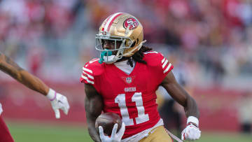 Dec 24, 2022; Santa Clara, California, USA; San Francisco 49ers wide receiver Brandon Aiyuk (11) runs with the ball during the third quarter against the Washington Commanders at Levi's Stadium. Mandatory Credit: Sergio Estrada-USA TODAY Sports