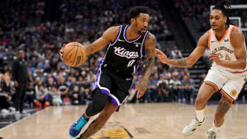 Mar 7, 2024; Sacramento, California, USA; Sacramento Kings guard Malik Monk (0) dribbles past San Antonio Spurs guard Devin Vassell (24) in the first quarter at the Golden 1 Center. Mandatory Credit: Cary Edmondson-USA TODAY Sports