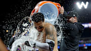 Sep 6, 2024; New York City, New York, USA; New York Mets third baseman Mark Vientos (27) doused with gatorade by right fielder Tyrone Taylor (15) and starting pitcher David Peterson (23) following his tenth inning walkoff two run home run against the Cincinnati Reds at Citi Field. Mandatory Credit: Brad Penner-Imagn Images