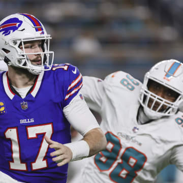 Jan 7, 2024; Miami Gardens, FL; Buffalo Bills quarterback Josh Allen (17) runs with the football against the Miami Dolphins during the second quarter at Hard Rock Stadium. 