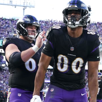 Dec 31, 2023; Baltimore, Maryland, USA; Baltimore Ravens tight end Isaiah Likely (80) greeted by center Tyler Linderbaum (64) following his second quarter touchdown against the Miami Dolphins at M&T Bank Stadium. Mandatory Credit: Mitch Stringer-USA TODAY Sports