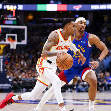 Apr 6, 2024; Denver, Colorado, USA; Atlanta Hawks guard Dejounte Murray (5) drives past Denver Nuggets forward Zeke Nnaji (22) in the second half at Ball Arena. Mandatory Credit: Michael Ciaglo-USA TODAY Sports