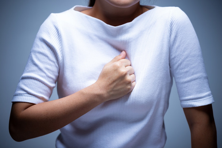 Woman pressing her hand to her chest