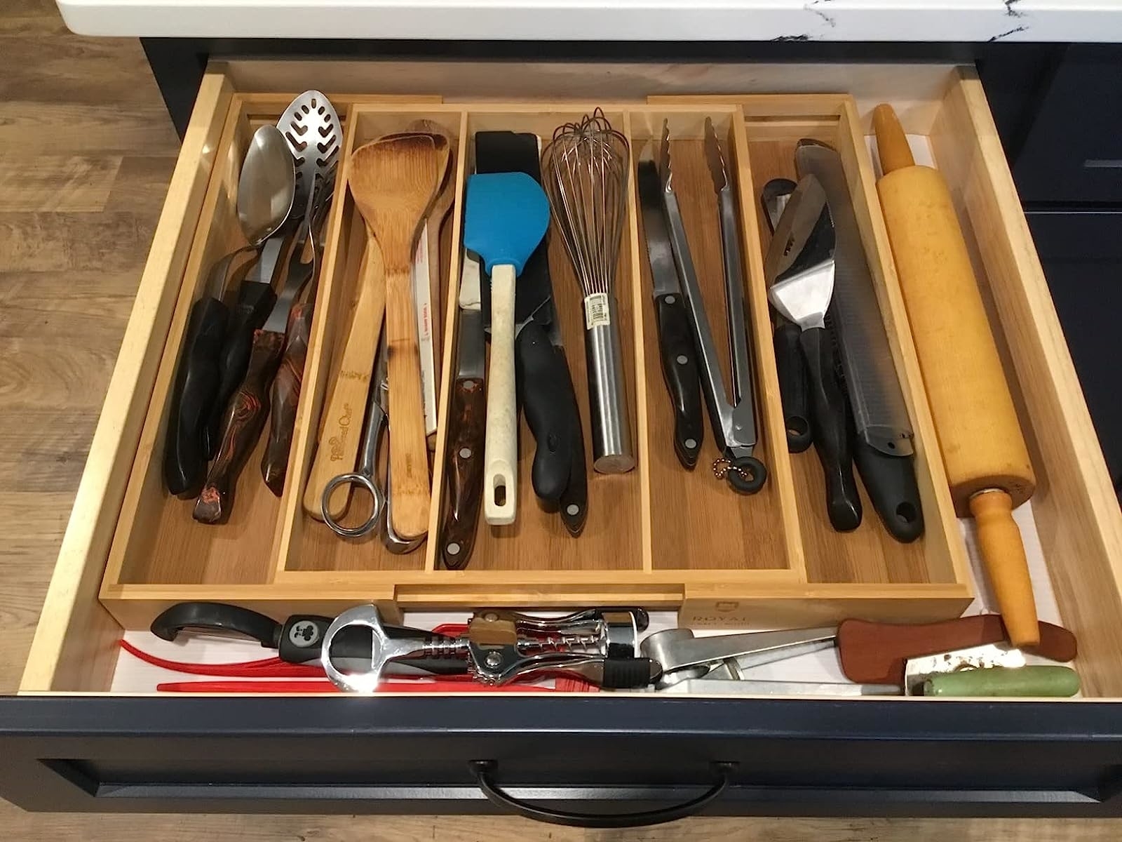 Reviewer&#x27;s bamboo organizer in drawer with kitchen utensils