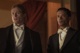 Jacob Anderson and Sam Reid dressed in formal attire with bow ties, standing together in an indoor setting