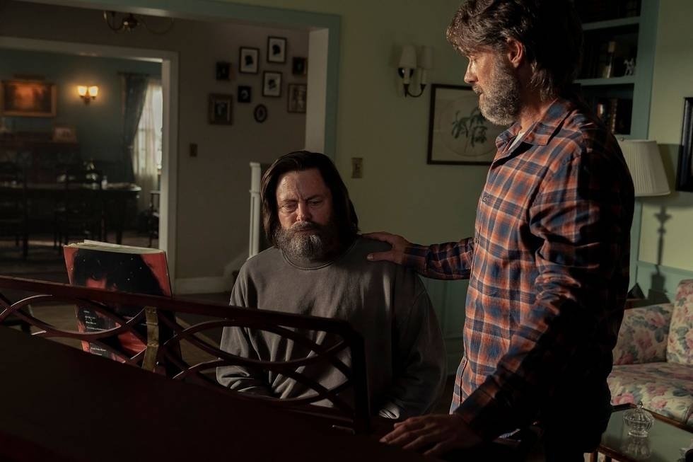 Nick Offerman and Murray Bartlett by a piano in casual clothing in &quot;The Last of Us.&quot;