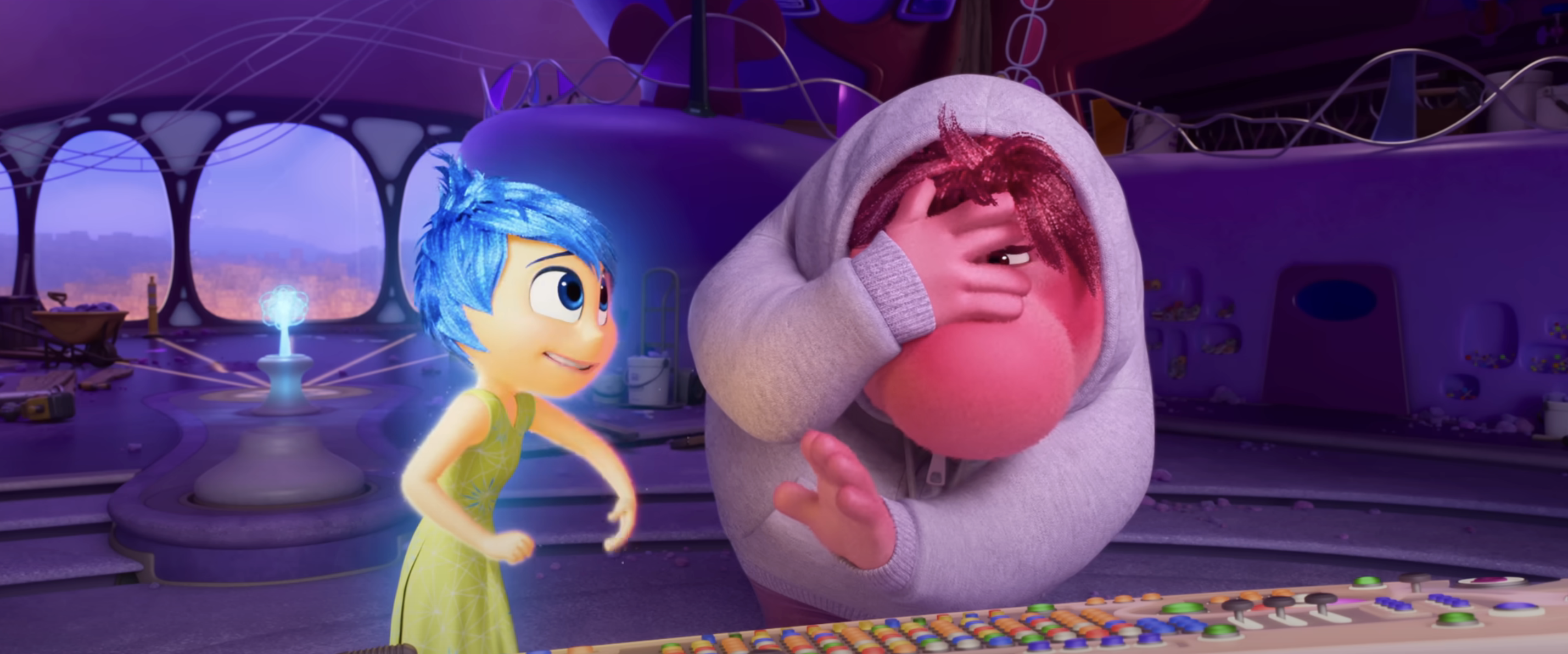 Animated characters in a futuristic room; one is cheerful, wearing a dress, and the other looks frustrated, covering their face from Inside Out 2