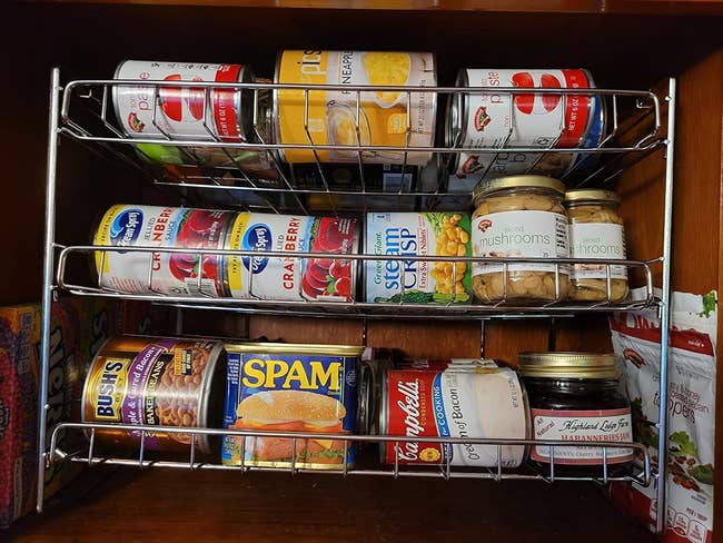 A reviewer photo of a well-organized pantry shelf with various canned foods, including Bush's beans, SPAM, Campbell's soup, mushrooms, and marinated artichoke hearts