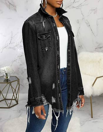 Model wearing product with white shirt and blue jeans in front of a marble wall