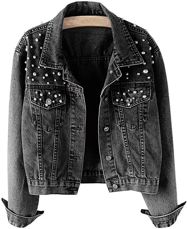 Black short vintage wash denim jacket with pearl embellishments on a white background