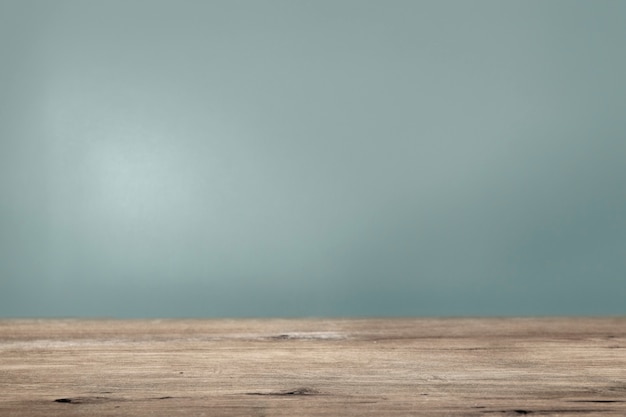 Foto gratuita parete verde acqua semplice con sfondo del prodotto del pavimento in legno