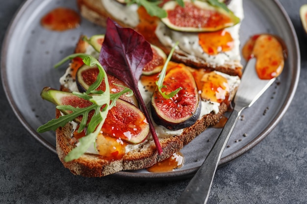 Foto gratuita panino con fichi su crema di formaggio con marmellata servito su piatto