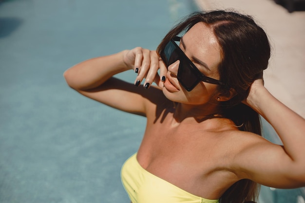 Foto una ragazza piuttosto abbassata che posa in piscina.