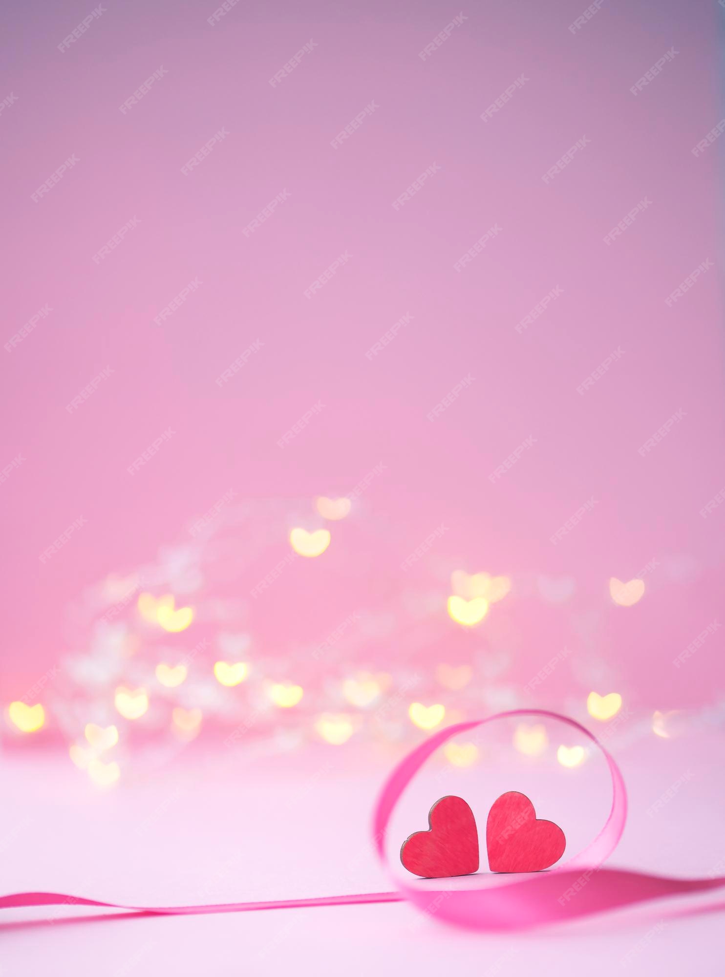 Premium Photo | Two pink hearts on a background of lights in the form of  hearts concept for love