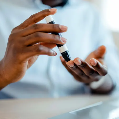 photo of man using glucometer