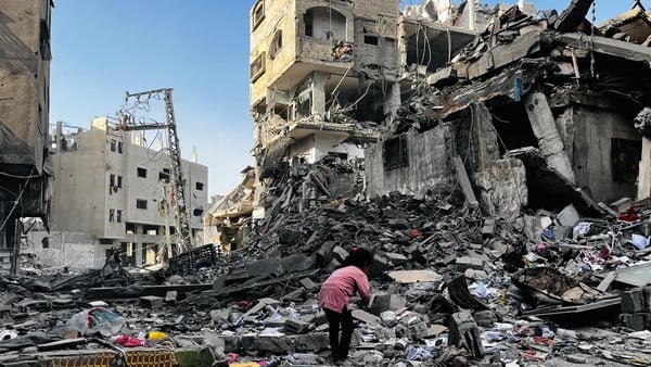 A Palestinian girl inspects the rubble of a building after an Israeli strike in Beit Lahia in the northern Gaza on October 29