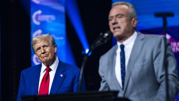 Robert F Kennedy Jr speaks with Republican presidential nominee Donald Trump at a rally in Duluth, Georgia on 23 October