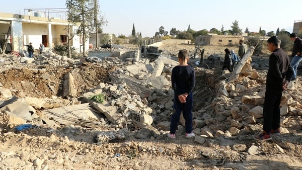 People check damage following an Israeli strike in the village of Douris in the Baalbek district of eastern Lebanon