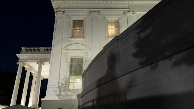 The shadow of a grounds keeper is cast on to the wall of the White House on November 9, 2020 in Washington, DC. U.S. 