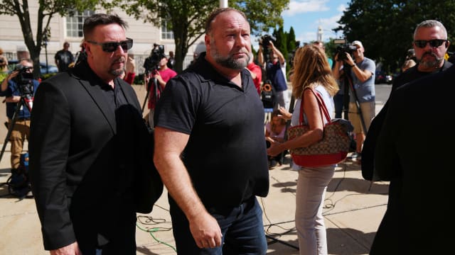 InfoWars founder Alex Jones walks outside Waterbury Superior Court during his trial in 2022. 