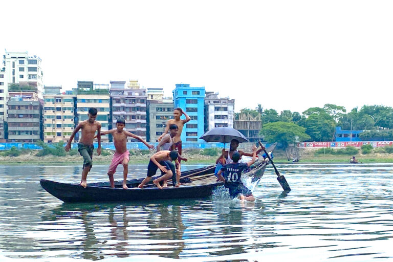 Boys swim in the Buriganga River near Dhaka during a heat wave in May 2024.