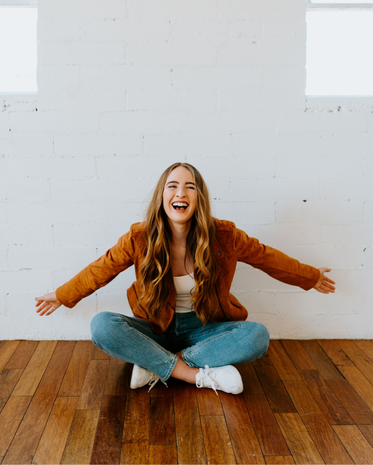 kat sitting on wooden floor