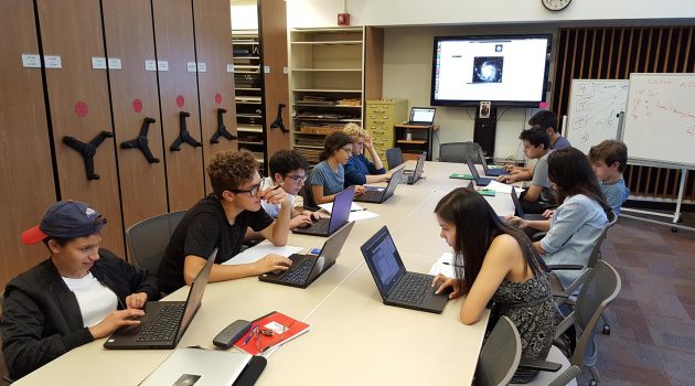 High school students in the first cohort of the Science Research Mentoring Program learn how to work with astronomical images in the Harvard-Smithsonian Center for Astrophysic's Wolbach Library.