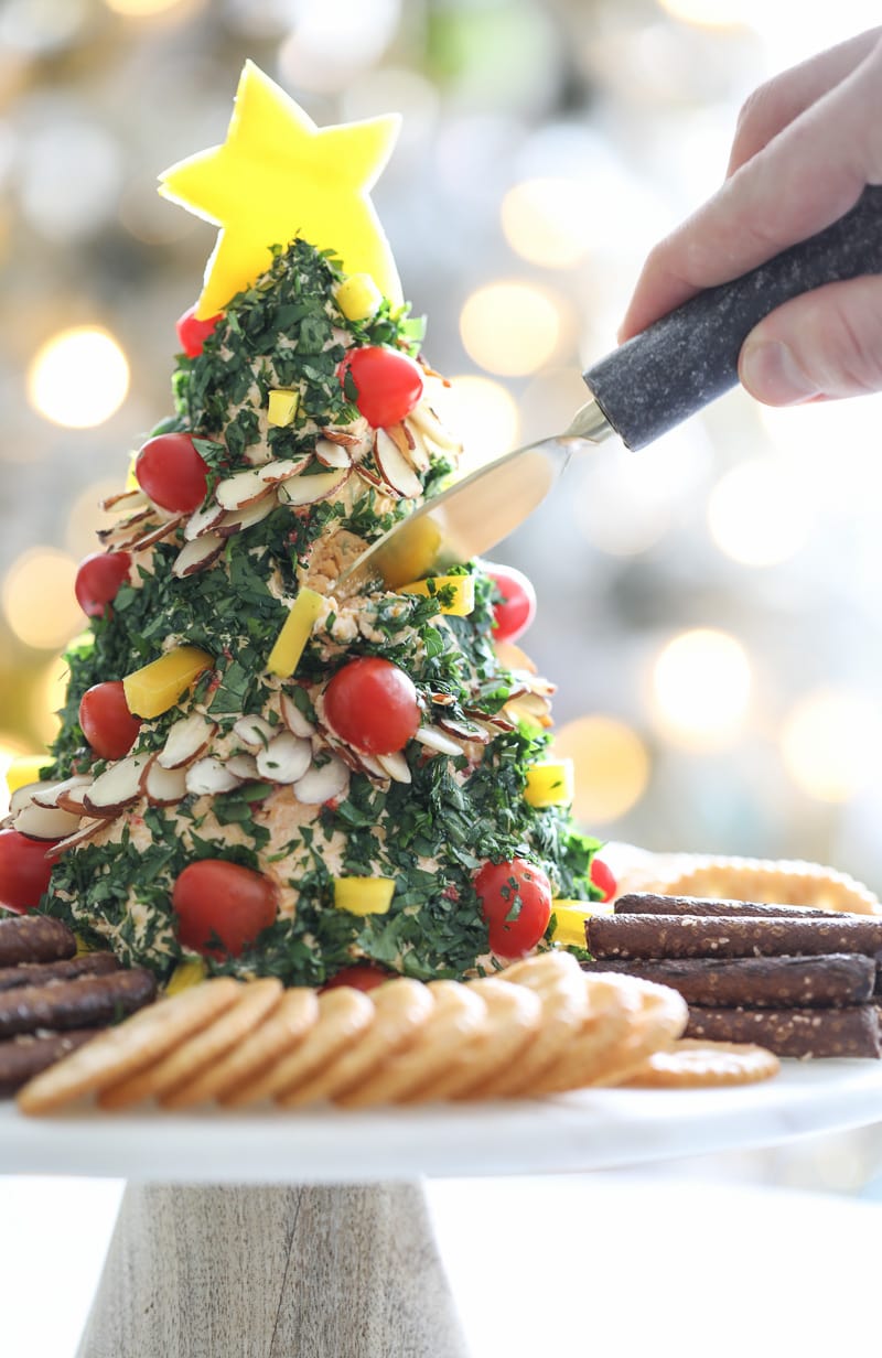 a cheeseball shaped and decorated like a Christmas tree for festive holiday snacks