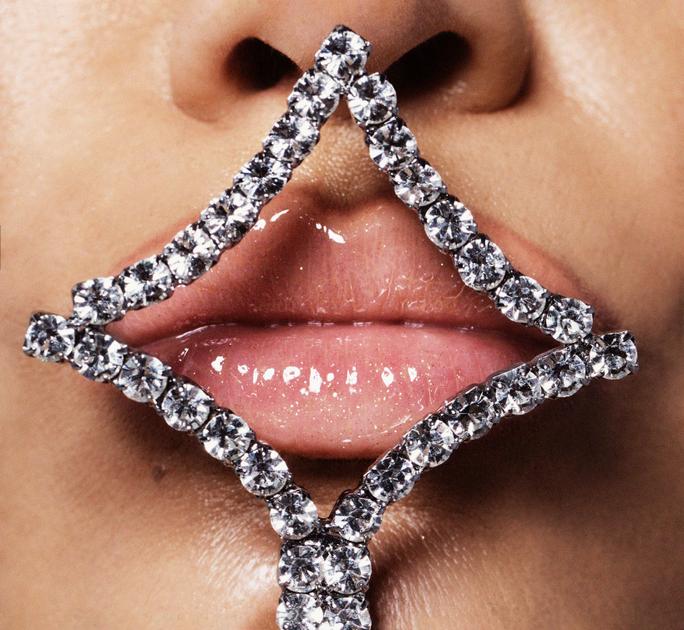 Close-up photo of Jennifer Lopez’s lips wearing pink lip gloss and framed by a diamond-shaped crystal barrette for Allure Magazine’s March 2021 cover story.